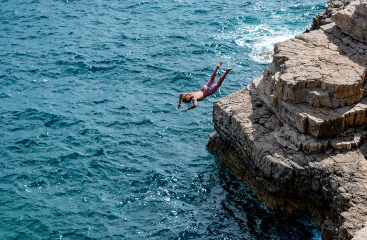 Man cliff diving in Pula Croatia